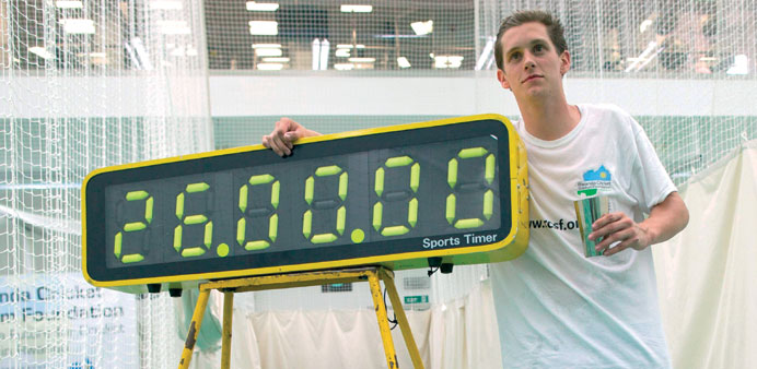 Alby Shale poses next to an electronic timer after batting for 26 hours at the Oval cricket club in London. (AFP)   