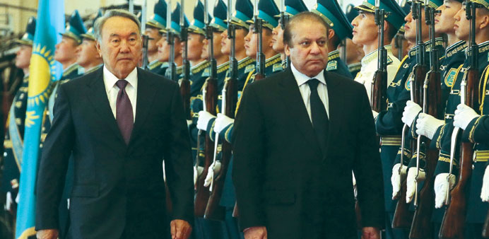 Kazakh President Nursultan Nazarbayev and Pakistani Prime Minister Nawaz Sharif review an honour guard during a welcoming ceremony in Astana yesterday