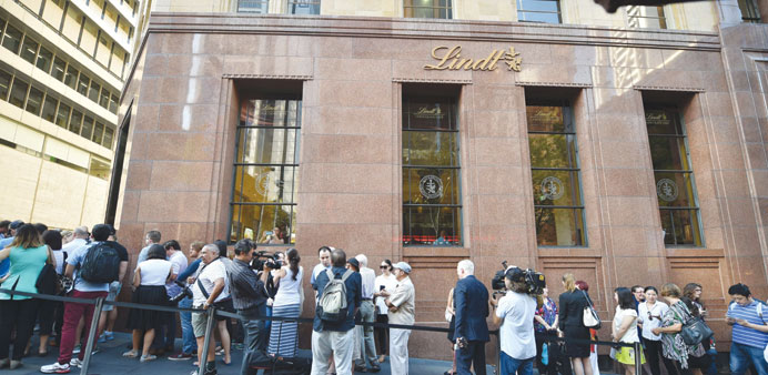 Members of the public queue outside the Lindt Cafe at Martin Place in Sydney ahead of the reopening yesterday.