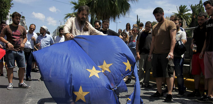 Anti-EU protesters burn a European Union flag in Athens, Greece