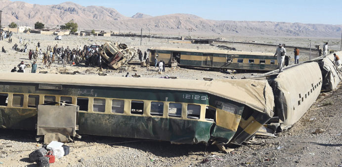 Pakistan security officials inspect damaged carriages following the derailment of a passenger train in Bolan district, some 75km from Quetta, yesterda