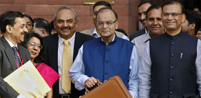 India's Finance Minister Arun Jaitley (C) poses as he leaves his office to present the 2015/16 federal budget in New Delhi 