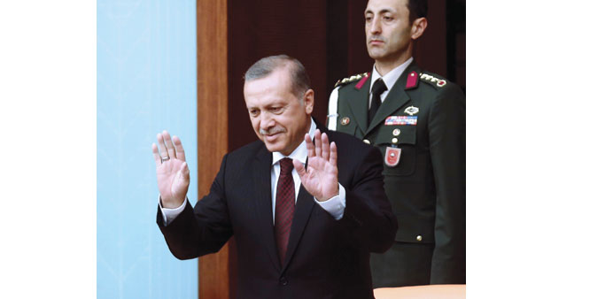 Erdogan greets members of parliament as he arrives for a swearing-in ceremony at the Turkish parliament in Ankara.