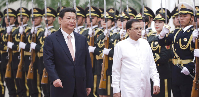 Sri Lankau2019s President Maithripala Sirisena  and Chinau2019s President Xi Jinping inspect a honour guard.