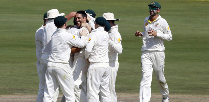 Australiau2019s Mitchell Johnson (centre) celebrates with teammates after taking the wicket of South Africau2019s JP Duminy during the fourth day of their fir