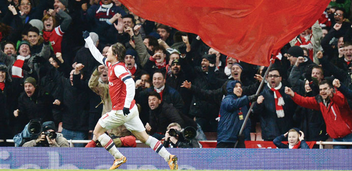 Arsenalu2019s Tomas Rosicky celebrates after scoring the teamu2019s second goal against Tottenham Hotspur during an English FA Cup third round match in London