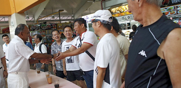 Singaporeu2019s Foreign Minister K Shanmugam of the ruling Peopleu2019s Action Party speaking with residents during a visit to a hawker centre in Singapore. T