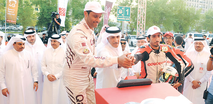 Ooredoo Group chairman HE Sheikh Abdullah bin Mohamed bin Saud al-Thani with Olympic medallist and rally driver Nasser al-Attiyah at the opening of Oo