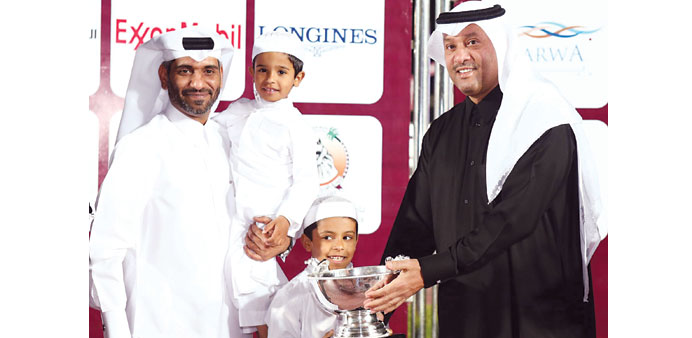 Secretary to HH the Emir for Family Affairs HE Sheikh Hassan bin Khalid al-Thani (right) presents the Umm Al Tage Cup to Jassim Abdulaziz al-Boenain a
