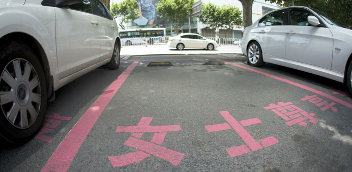A marked-out parking space in front of the Dashijiedaduhui centre in the seaport city of Dalian. The sign post reads: u201cRespectfully reserved for women