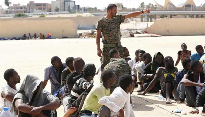 Migrants rescued by the Libyan coastguard at sea sit in a naval base near the capital Tripoli yesterday. AFP