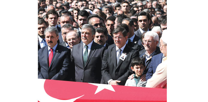 Turkeyu2019s Prime Minister Ahmet Davutoglu (second right) and former president Abdullah Gul (second left) attend the funeral of prosecutor Mehmet Selim K