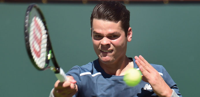 Milos Raonic of Canada hits a forehand return to Rafael Nadal of Spain during their quarter-final match at the BNP Paribas Tennis Open in Indian Wells