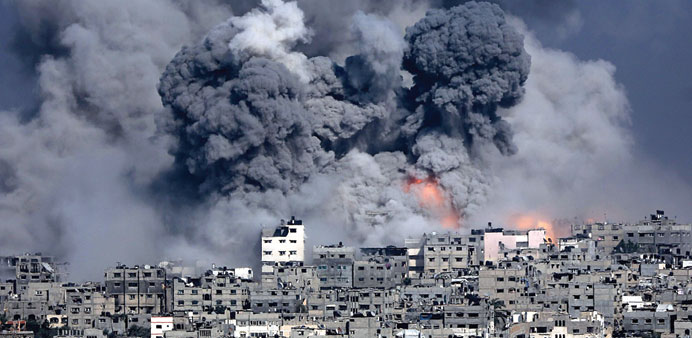Smoke rising from Tuffah neighbourhood after Israeli air strikes in the east of Gaza City yesterday. 