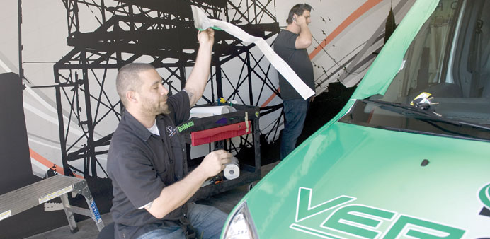 * Technician Shane Doser installs a vehicle wrap at Iconography Studios.