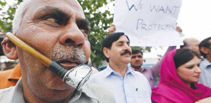 A Pakistani journalist locks his face in a show of protest against the attack on TV anchor Hamid Mir, in Peshawar, yesterday.