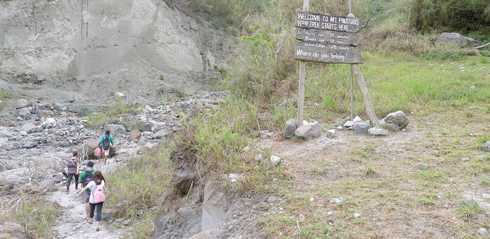 ON THE WILD SIDE: A sign marks the last kilometre of a trek to the flooded caldera of Mount Pinatubo in the northern Philippines. On the last leg, the