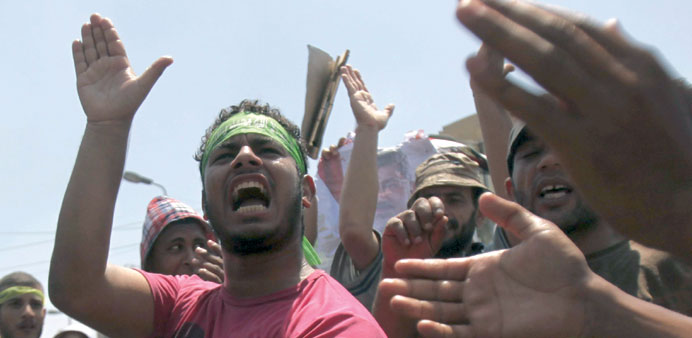 Supporters of ousted Egyptian President Mohamed Mursi shouting slogans during a protest at the Rabaa al-Adawiya Square, in the Nasr city area, east of