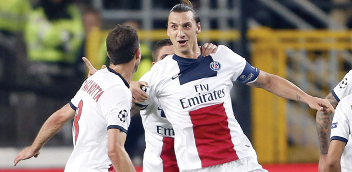 Paris Saint-Germainu2019s Zlatan Ibrahimovic (R) celebrates after scoring against Anderlecht during their Champions League match at Constant Vanden Stock 