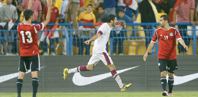 Qataru2019s Majed Ibrahim (Centre) celebrates scoring a goal during their international friendly soccer match against Egypt in Doha. 