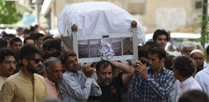 Pakistani relatives and activists carry the coffin of female rights activist Sabeen Mahmud killed in an attack in Karachi