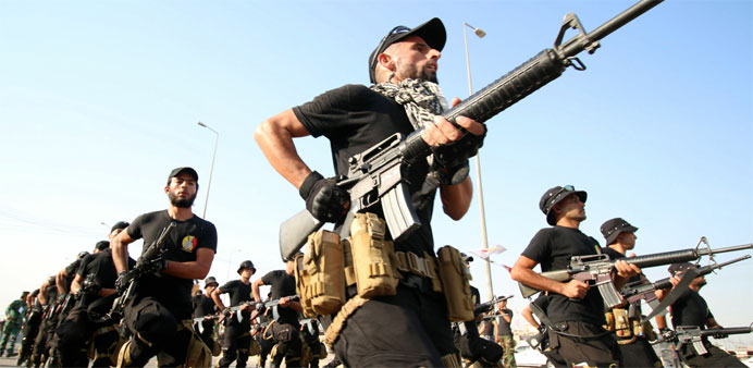 Fighters march during a military parade in the southern Iraqi city of Basra 