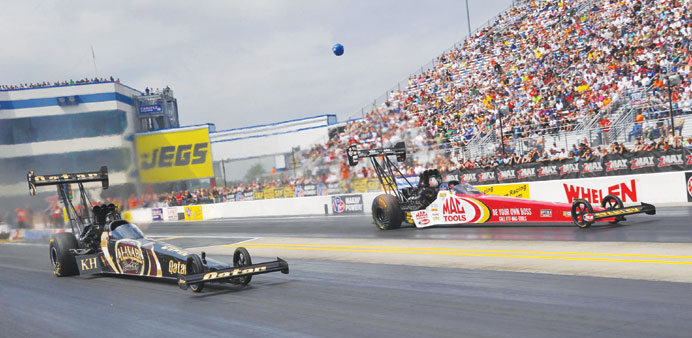 Dubai native Khalid al-Balooshi (near lane) races Doug Kalitta during the first round of eliminations on Sunday.