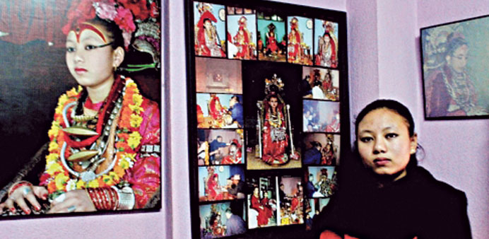 Chanira Bajracharya at home with pictures of her time as a Kumari.