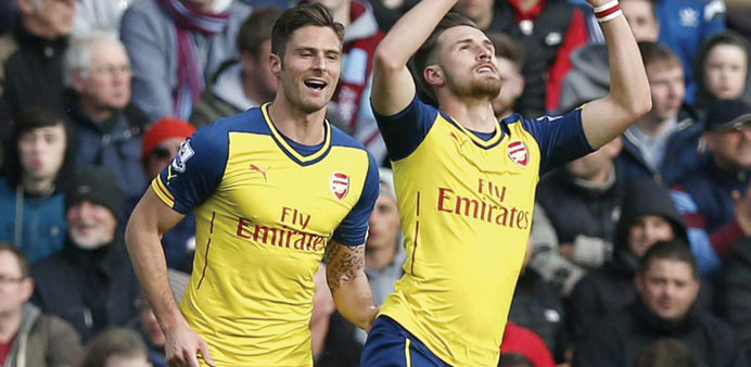 Arsenal's Aaron Ramsey celebrates his goal against Burnley with teammate Olivier Giroud yesterday. (Reuters)