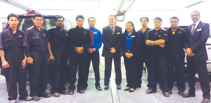 Alfardan Premier Motors body shop repair centre staff with  Jaguar Land Rover Mena officials.