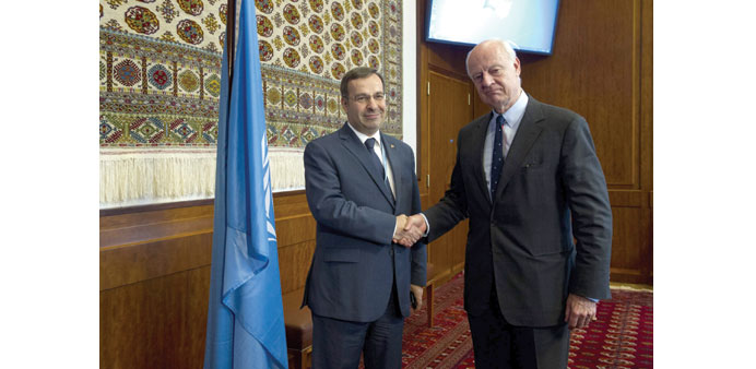  UN envoy Staffan de Mistura shakes hands with Syrian ambassador Hussam Eddin Ala at the UN offices in Geneva yesterday.