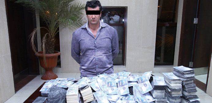 The suspect in the fake currency case with the notes recovered from him.
