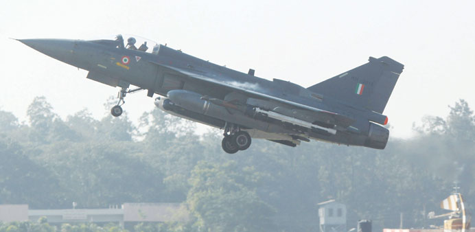 A HAL Tejas multirole light combat aircraft takes off for the initial operational clearance for induction into the Indian Air Force, in Bangalore yest