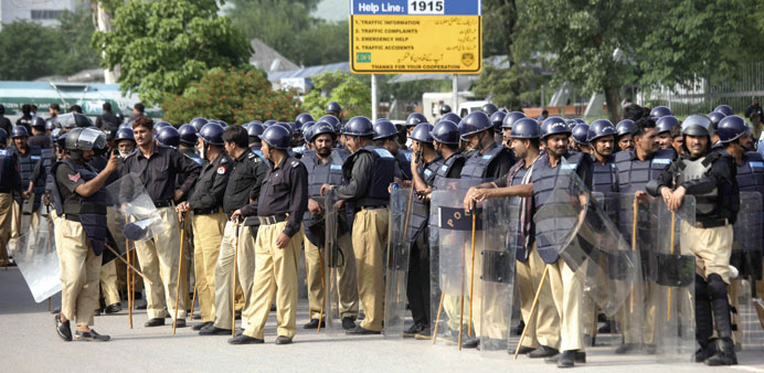 Riot police secure the parliament building in Islamabad yesterday.