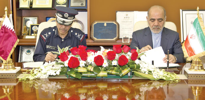 Staff Major General Saad bin Jassim al-Khulaifi and Ali Abdullahi signing the minutes yesterday.