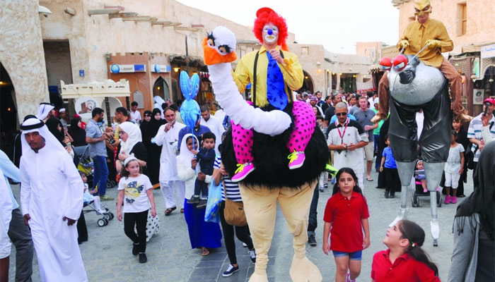  Performers walk down the Souq Waqif alley. PICTURE: Shemeer Rasheed.