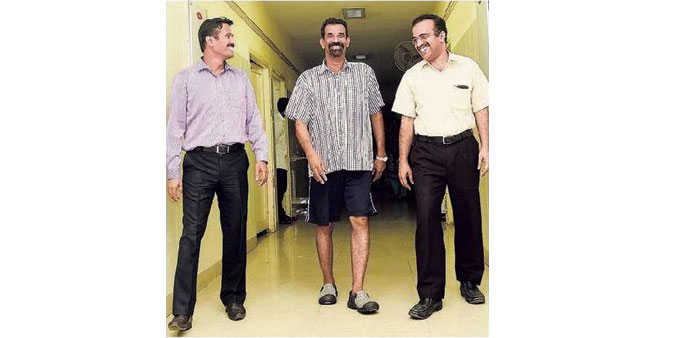 Varghese walk unaided in a hospital corridor.