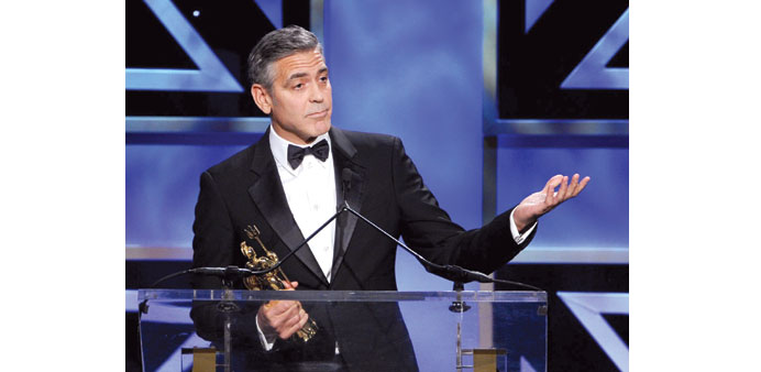 George Clooney, Benedict Cumberbatch (below left) and Sir Ben Kingsley accept their Bafta Britannia awards.   