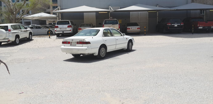 A car being parked in the middle of the road.