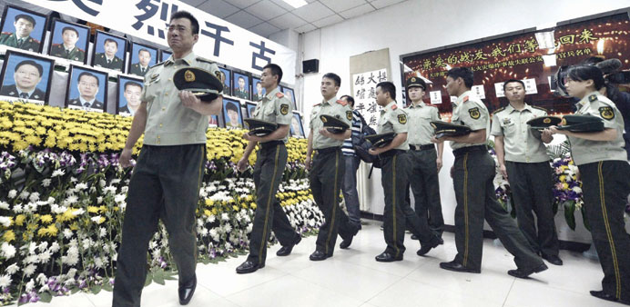 Paramilitary police mourn for firefighters and soldiers killed in Tianjin.