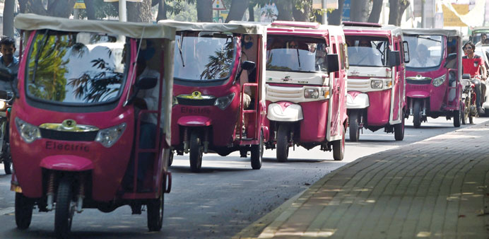 Pakistani women drive pink auto-rickshaws during a rally in Lahore yesterday.