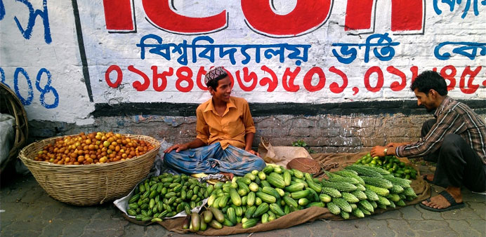 A street vendor displays fruits and vegetables for sale on a street in Dhaka.