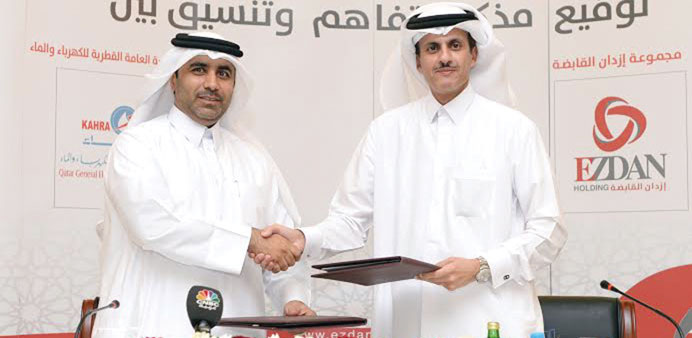 Kahramaa president Engineer Issa bin Hilal al-Kuwari (left) and Ezdan Holding chairman Sheikh Khalid bin Thani bin Abdulla al-Thani formalising the ag