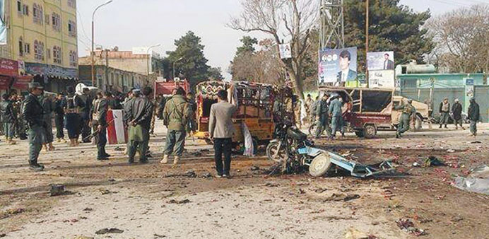 Afghan bystanders inspect the site of a suicide attack in Maimanah, the capital of Faryab province, north of Kabul.