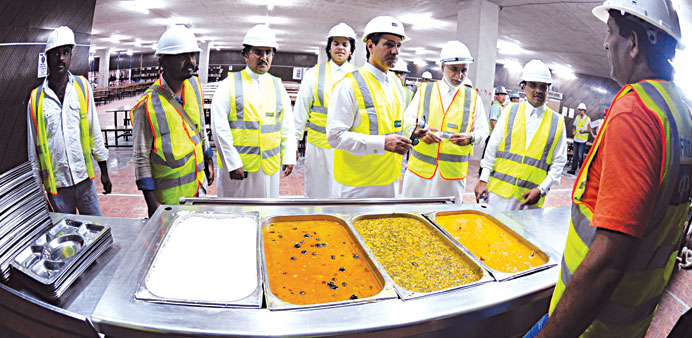 Labour ministry officials inspect the food at the QDVC labour camp.