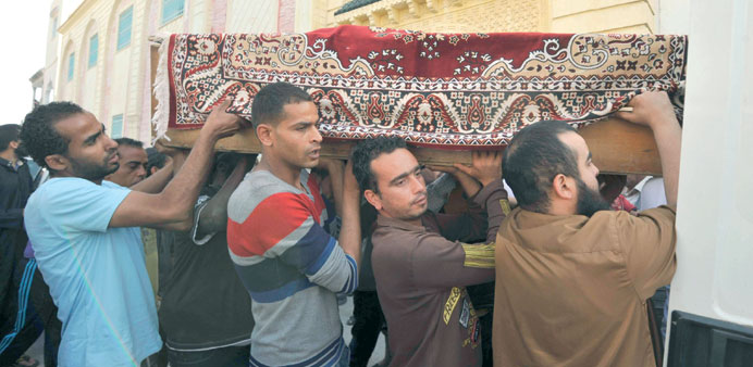 Mourners carry the body of a man killed in Sundayu2019s clashes, during his funeral in Ettadhamen yesterday.