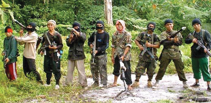 Abu Sayyaf insurgents pose in the jungle.