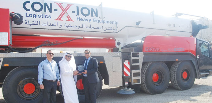 Officials in front of the Grove crane.