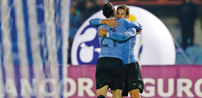 Uruguayu2019s Christian Stuani (right) is congratulated by team-mate Edinson Cavani after scoring a goal against Northern Ireland in Montevideo. (Reuters)