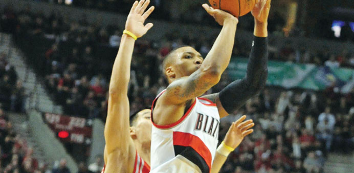 Damian Lillard of the Portland Trail Blazers hits a shot over Jeremy Lin of the Houston Rockets in the fourth quarter of Game Six of the NBA playoffs 